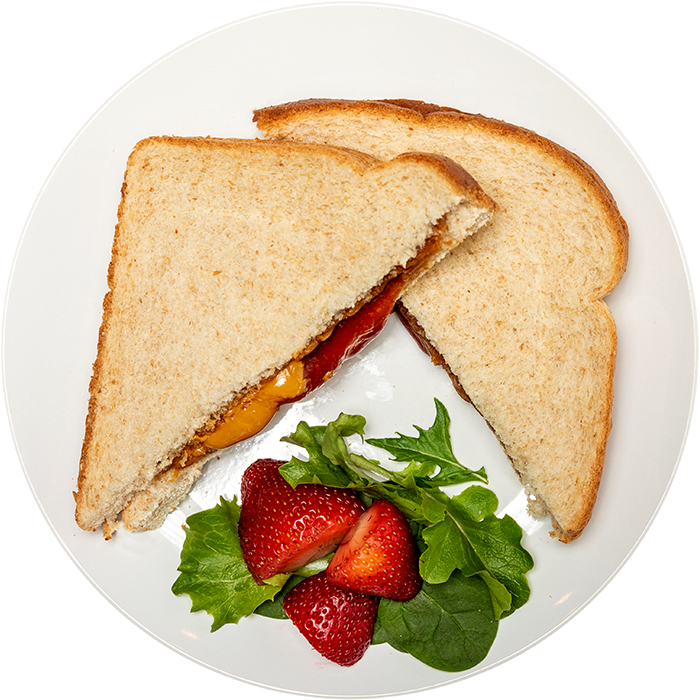 Image of the Wowbutter & Strawberry Jam EZ Jammer product on a plate, with other assorted foods